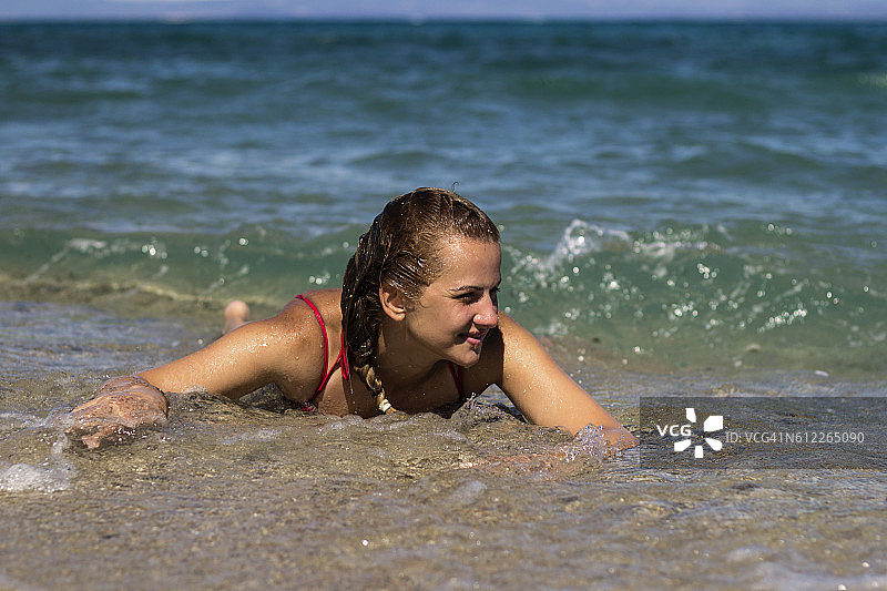 快乐轻松的年轻女子享受在沙滩上图片素材