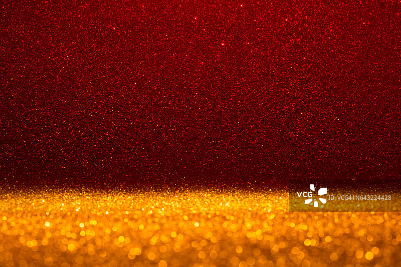 抽象背景充满了闪亮的金色和红色闪光图片素材