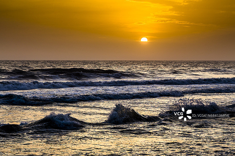 印度喀拉拉邦瓦尔卡拉海滩上的日落和海浪图片素材