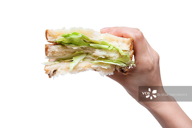 拿着一个孤立在白色背景上的蔬菜三明治图片素材