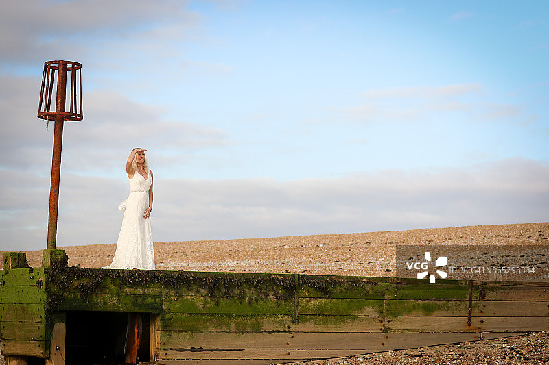 一个穿着婚纱的女人在海边图片素材