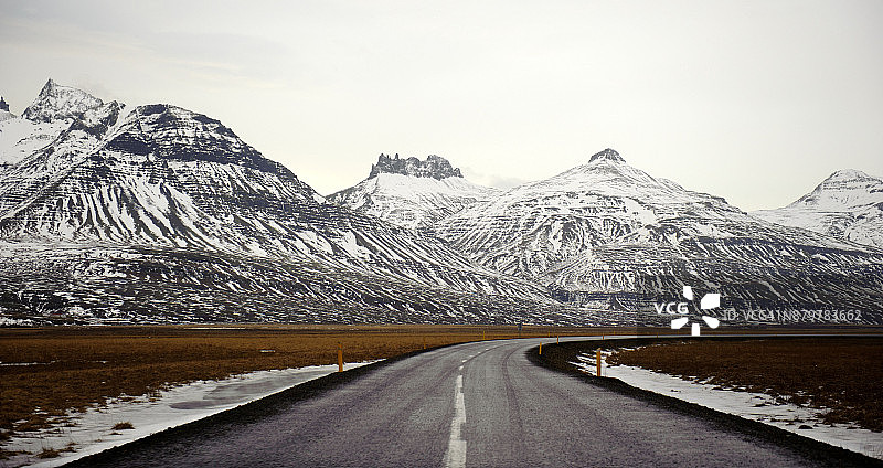 冰岛东部地区布里德达尔谢迪的公路和雪山图片素材