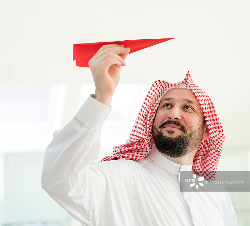 阿拉伯商人拿着纸飞机图片素材