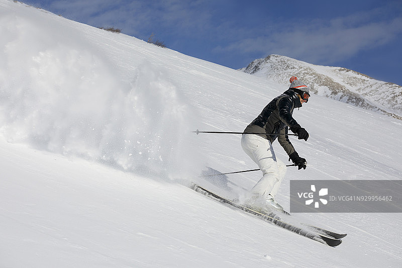 女子滑雪者在滑雪胜地滑雪业余冬季运动。高山雪景。意大利阿尔卑斯山上的多洛米特山脉。图片素材