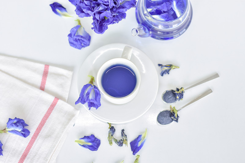 白色桌上草药茶的紫花高角度观图片素材