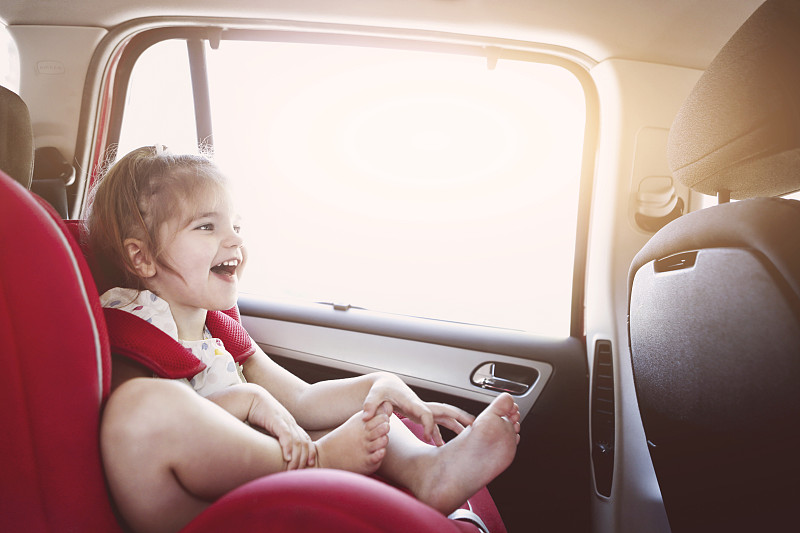 可爱的小女孩在汽车安全座椅微笑图片下载