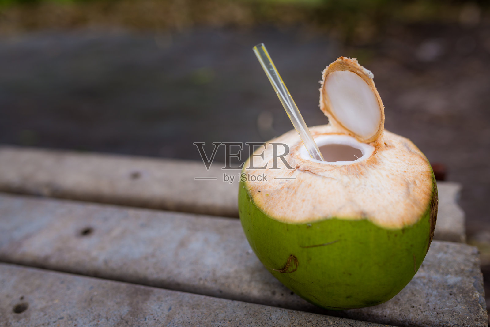 新鲜打开的椰子饮料与吸管照片摄影图片