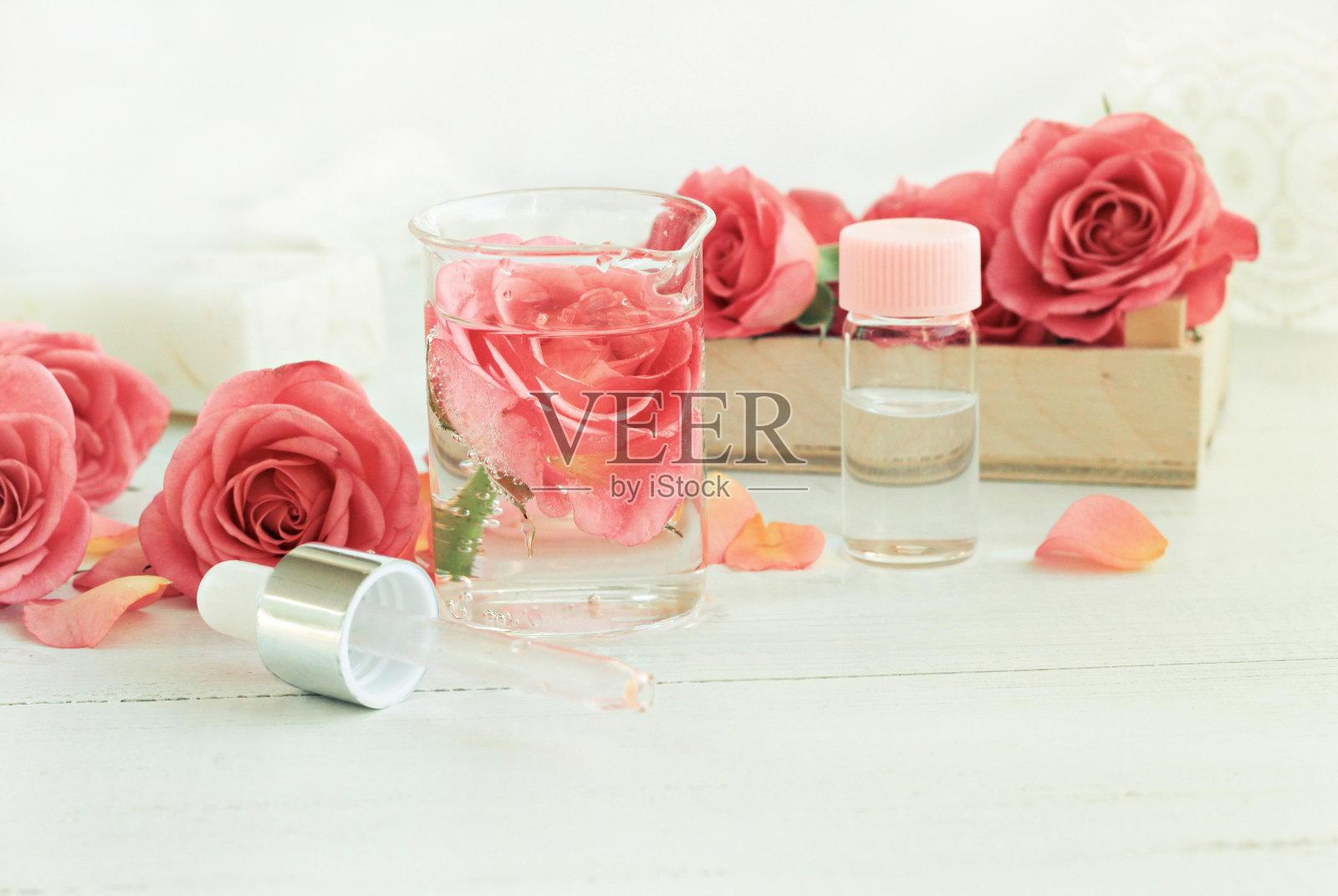 自制玫瑰爽肤水。玻璃花油罐，瓶子，吸管。照片摄影图片