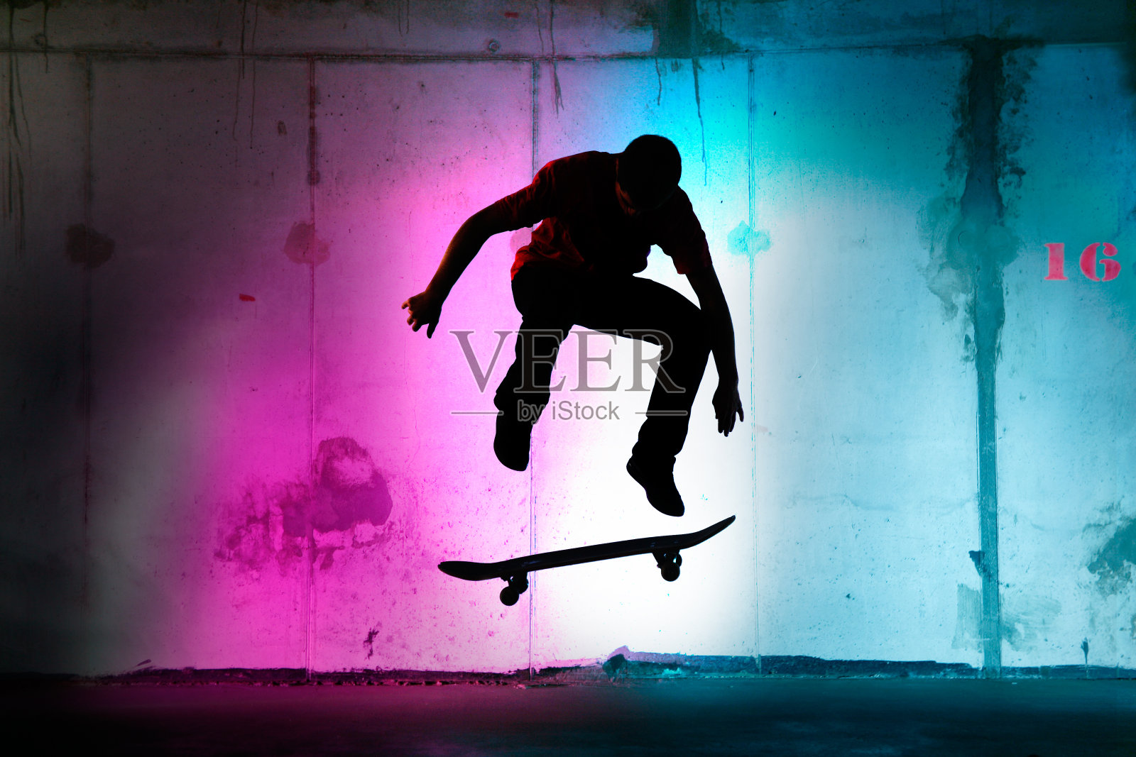 青少年在夜晚跳跃，玩滑板黑色的剪影照片摄影图片