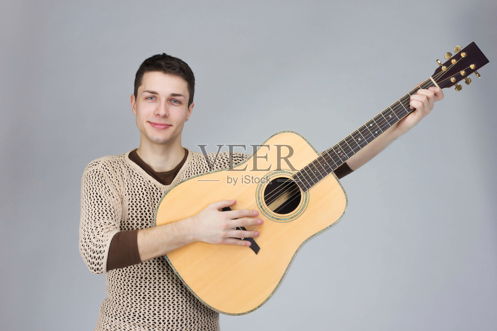 这家伙是个音乐家，吉他是灰色的照片摄影图片
