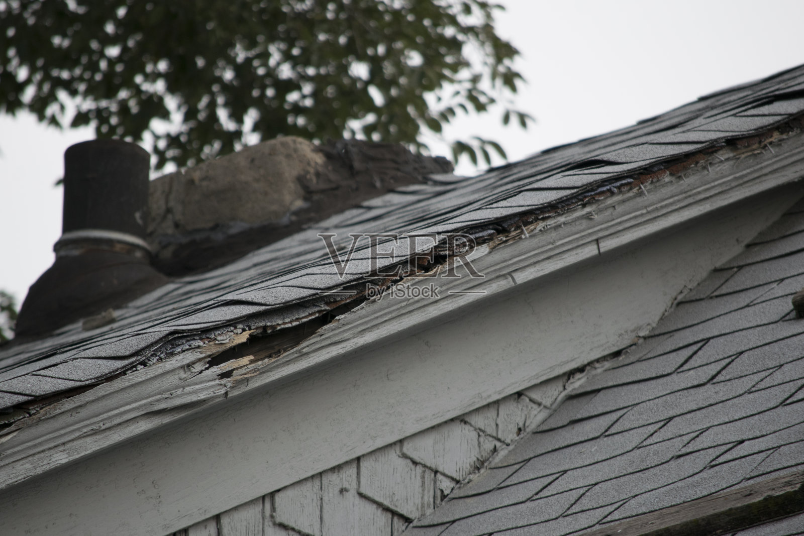 房屋上破损和旧的屋顶瓦和排水沟系统照片摄影图片