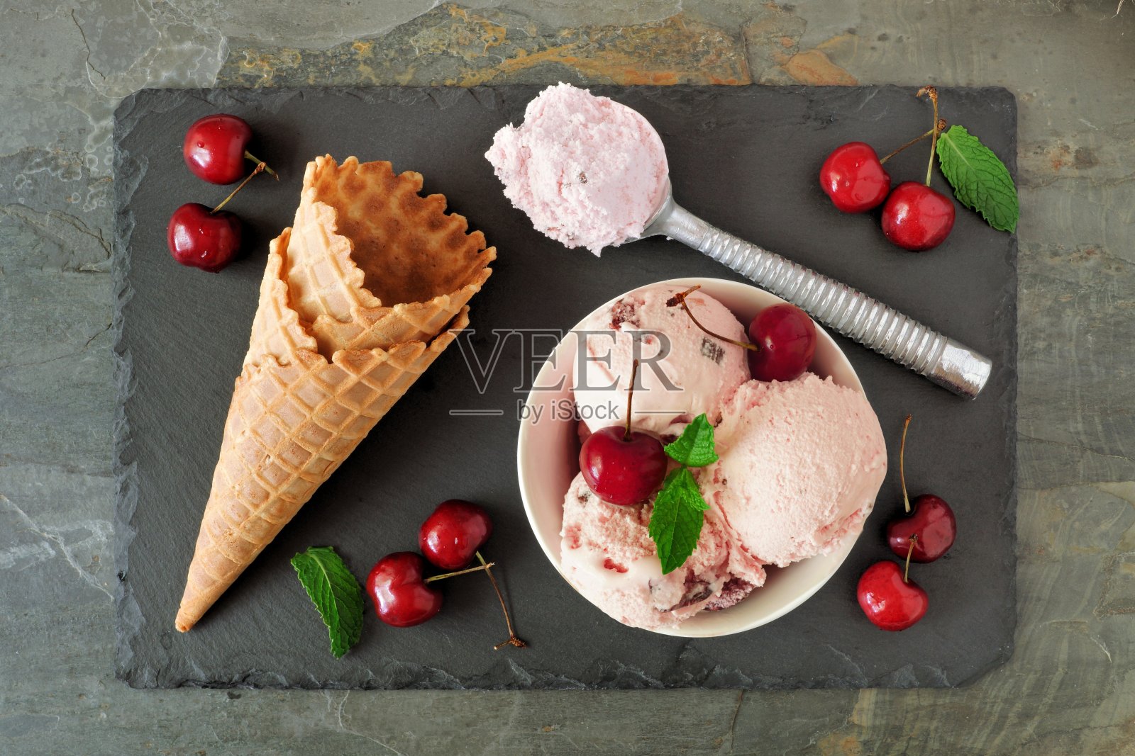 樱桃巧克力冰淇淋，上面是石板上的蛋卷照片摄影图片