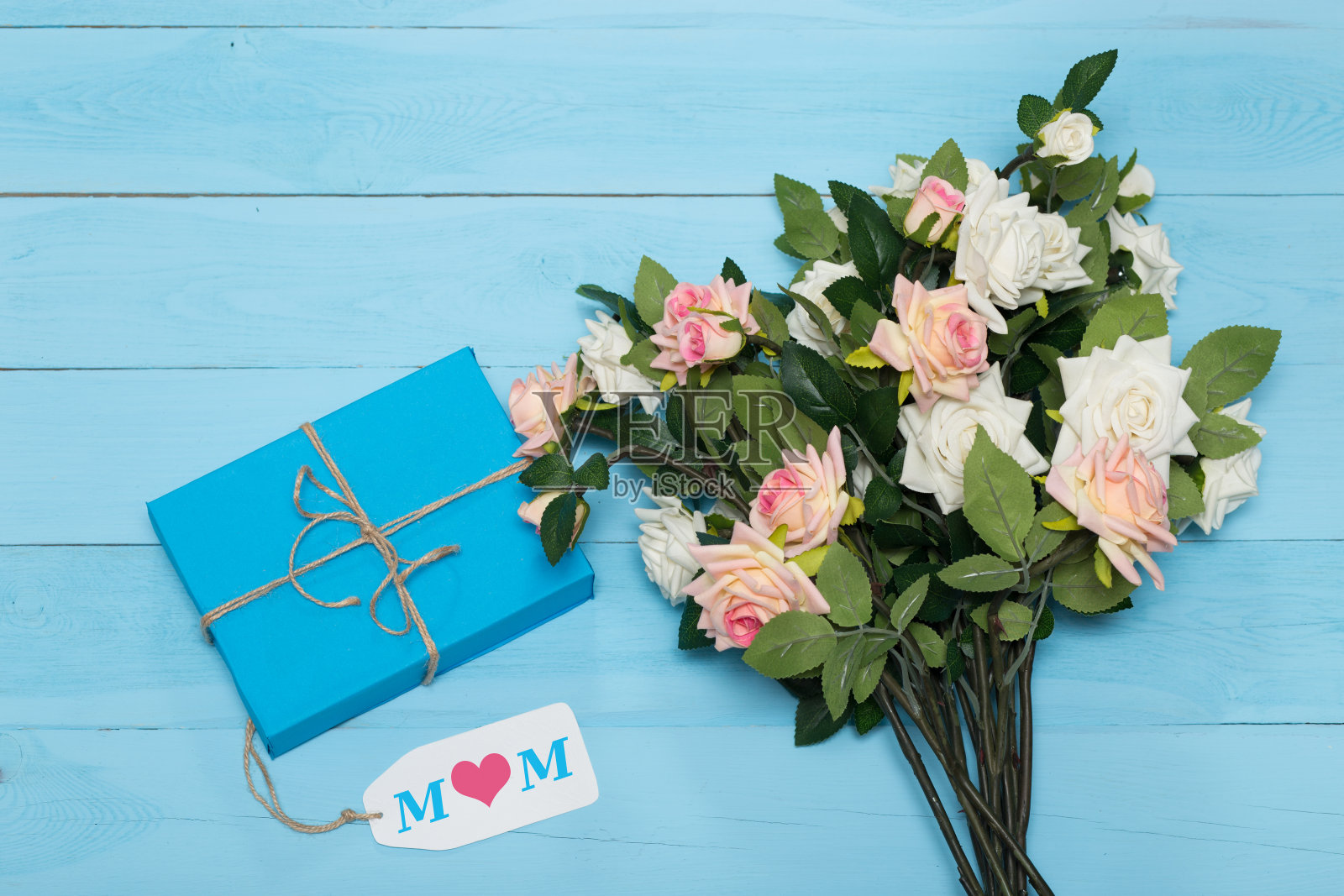 母亲节贺卡和蓝色背景的玫瑰与礼物照片摄影图片