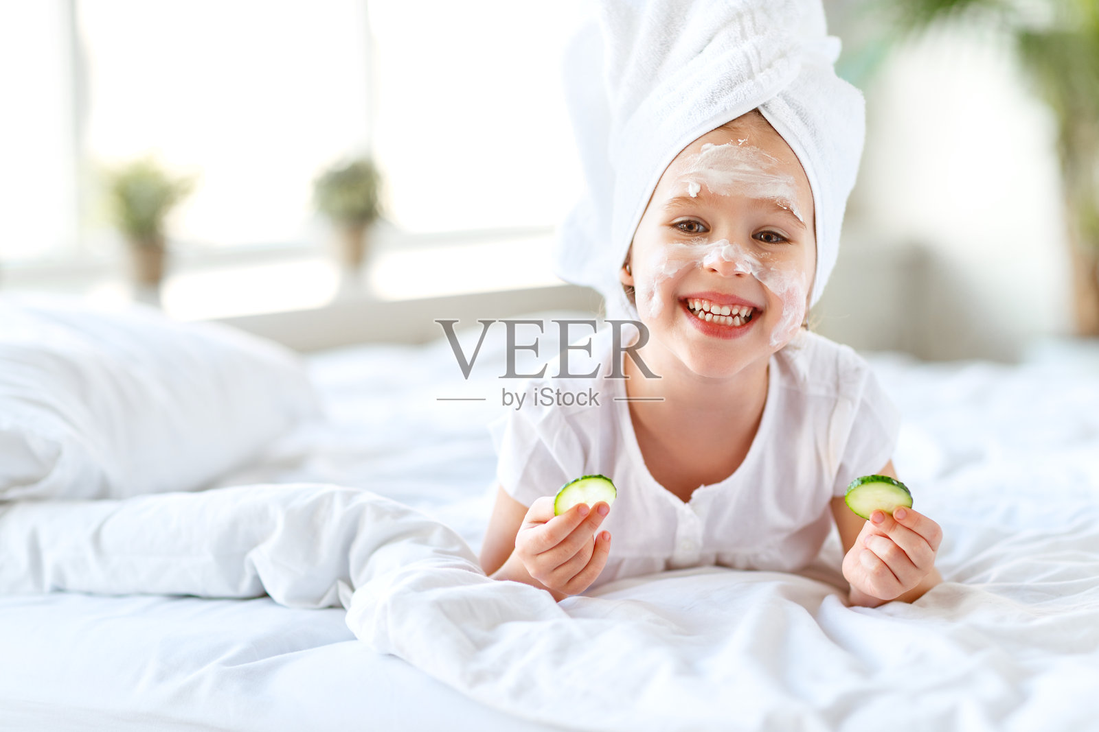 快乐的小女孩在毛巾和面具在脸上照片摄影图片