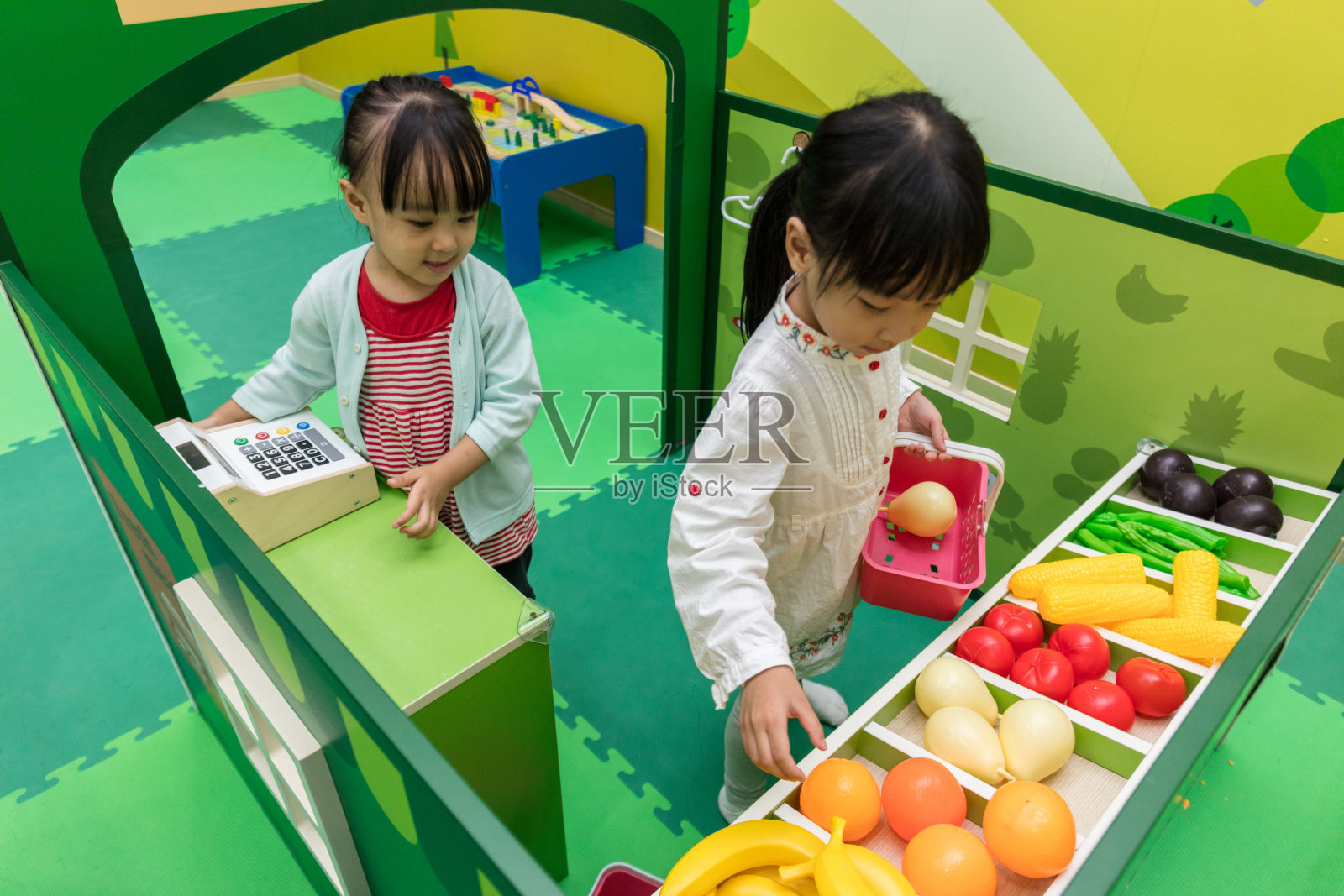 亚洲华人小女孩在水果店角色扮演照片摄影图片