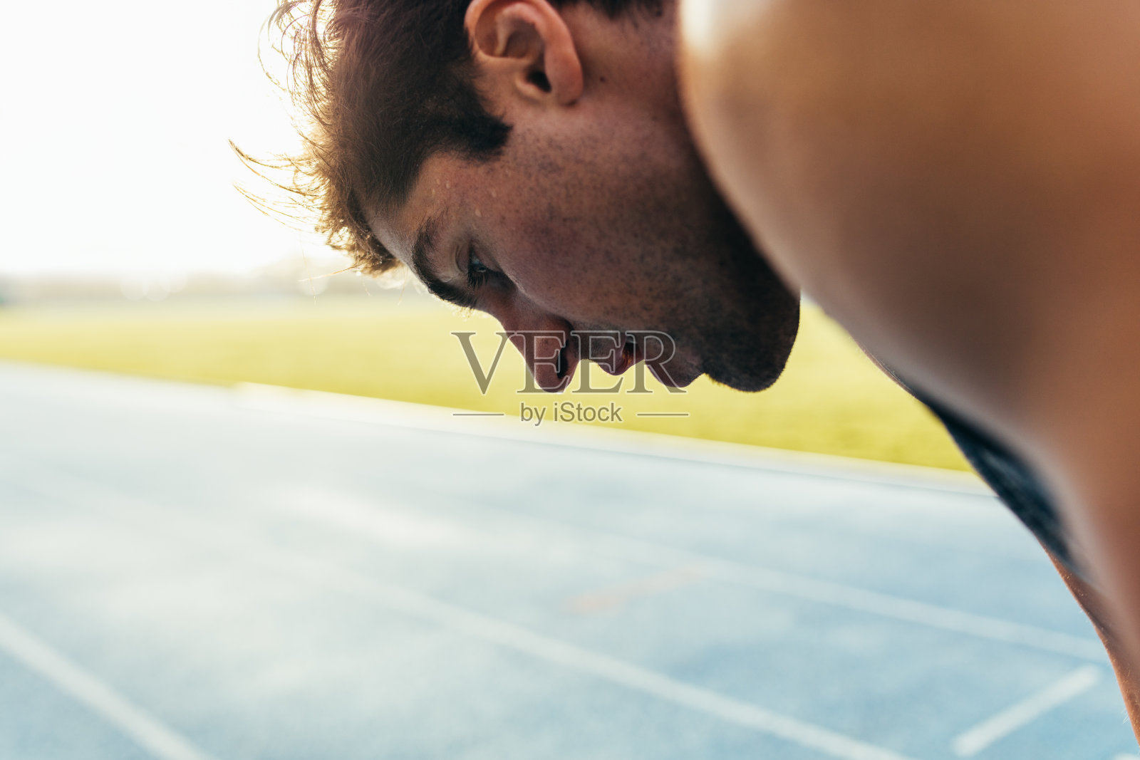 短跑运动员站在跑道上照片摄影图片