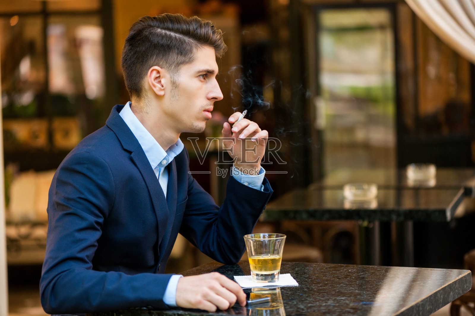 年轻严肃的商人抽烟喝酒照片摄影图片