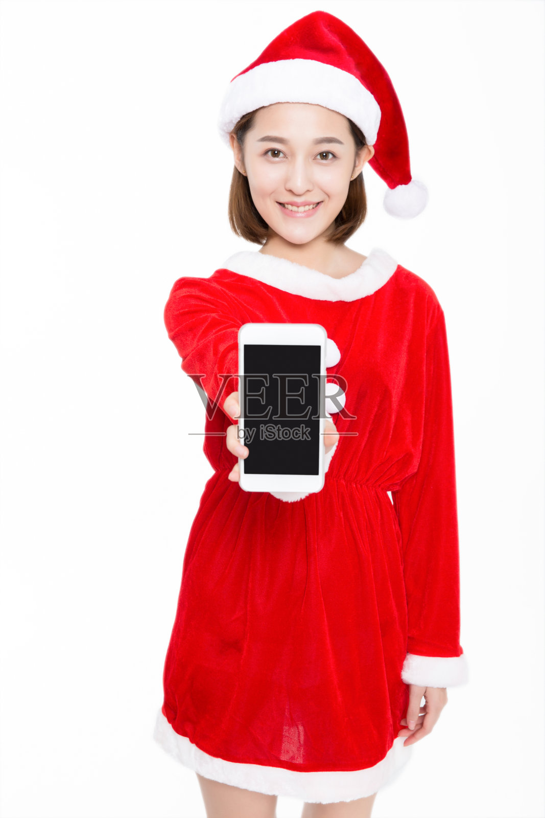 圣诞老人拿着白色背景的智能手机照片摄影图片