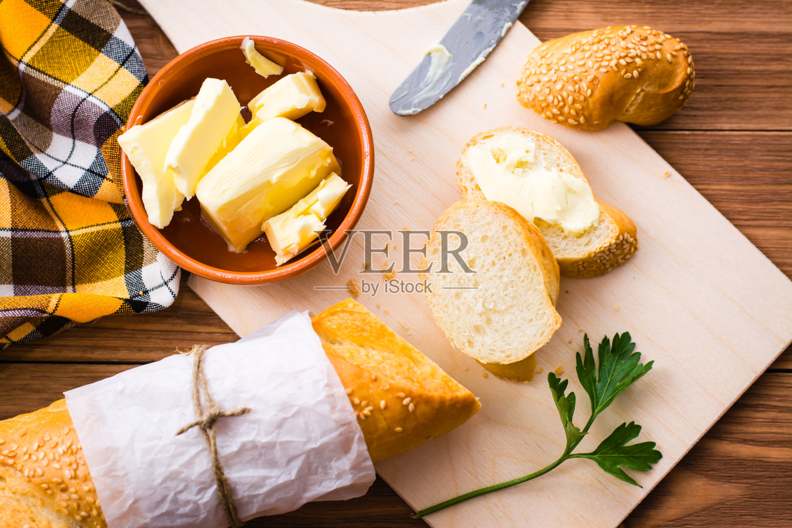 黄油三明治和切片法棍面包放在切菜板上照片摄影图片
