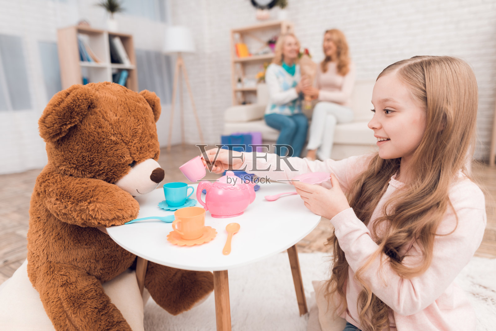 小女孩在玩玩具熊。照片摄影图片