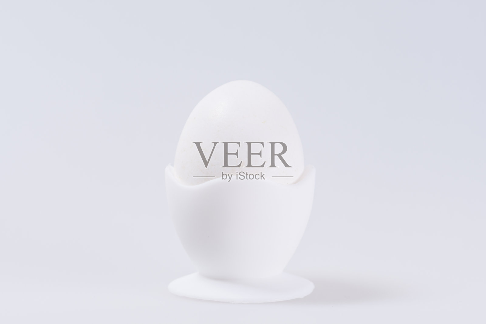 蛋杯中的白色蛋，在白色背景上留出文字空间照片摄影图片