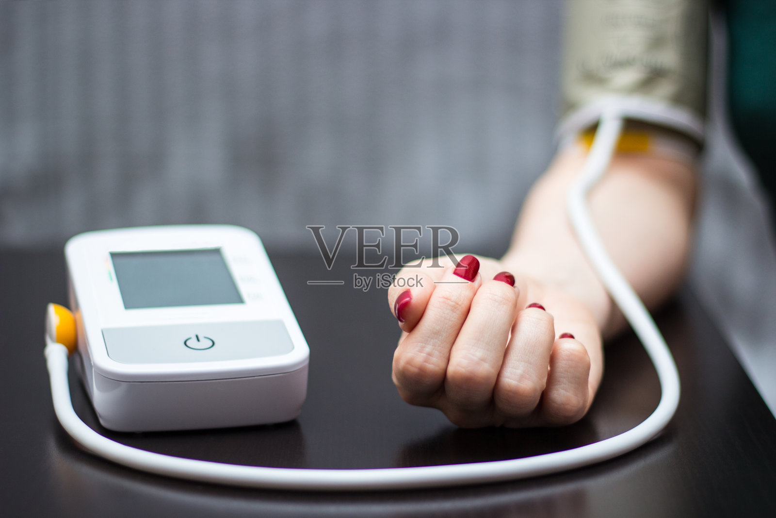 女人自己用血压计测血压照片摄影图片
