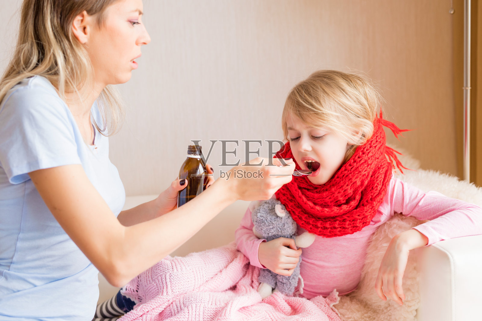 妈妈给生病的女儿喂糖浆照片摄影图片