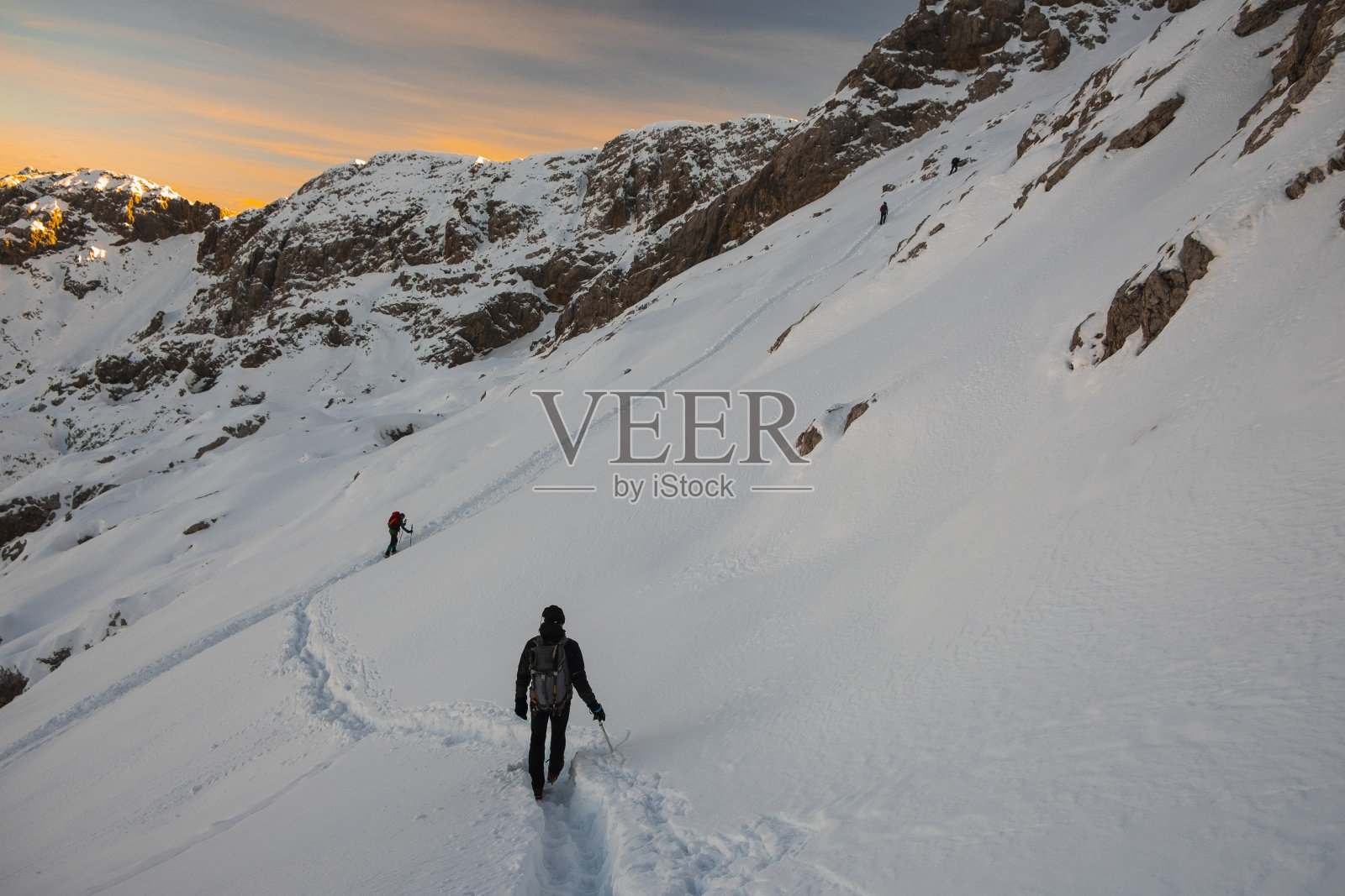 登山运动员在雪山上行走照片摄影图片