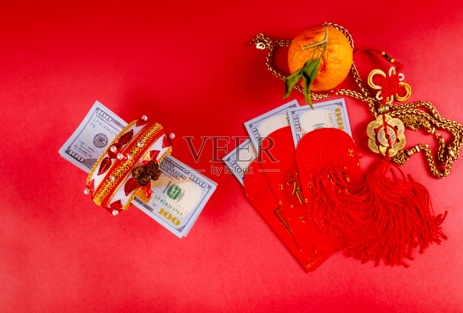 顶视图配件中国新年节日装饰的橘子、叶、红包和美元钱照片摄影图片