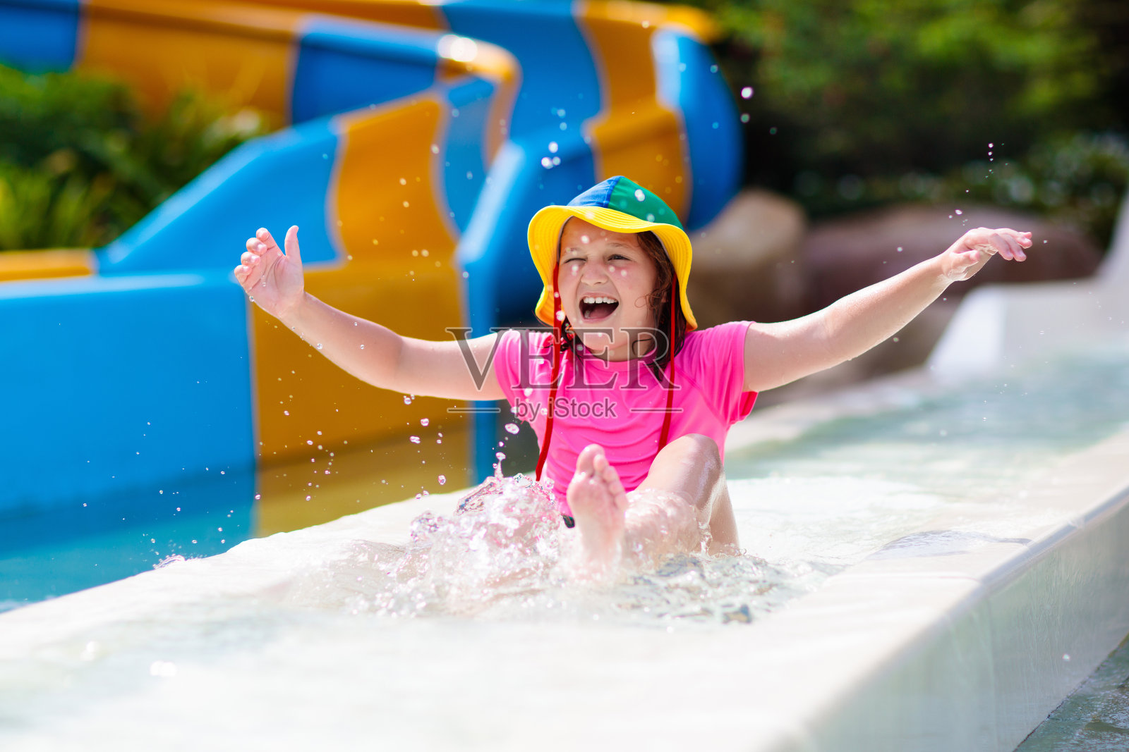 孩子们在水上乐园玩滑水。暑假照片摄影图片