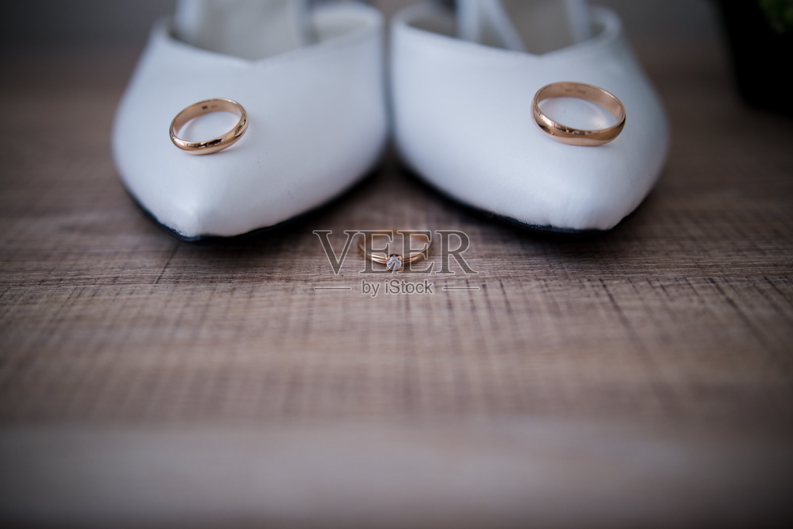 婚礼的金戒指在新娘的鞋子附近照片摄影图片