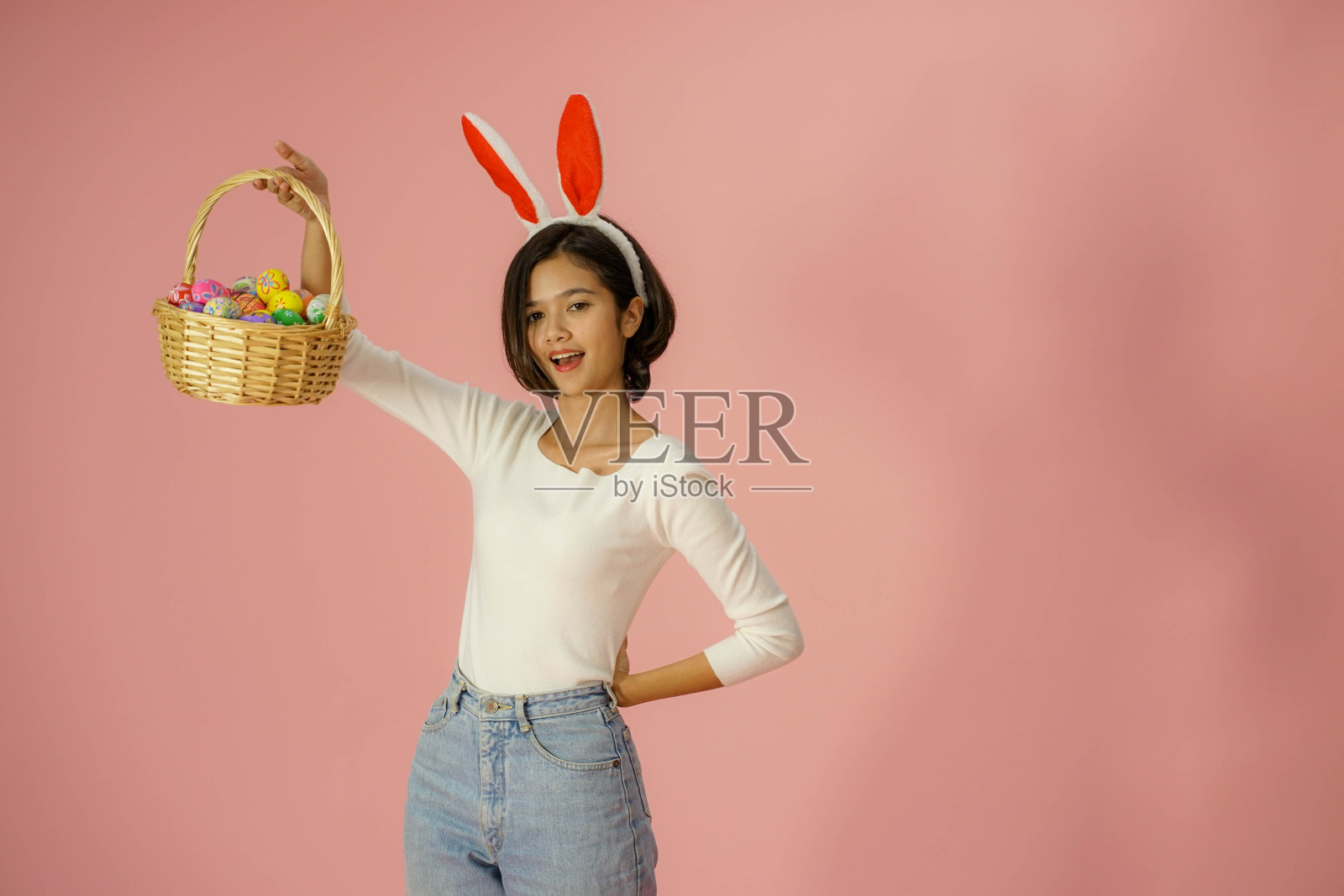年轻漂亮的亚洲人的肖像，五彩缤纷的复活节彩蛋篮子庆祝照片摄影图片