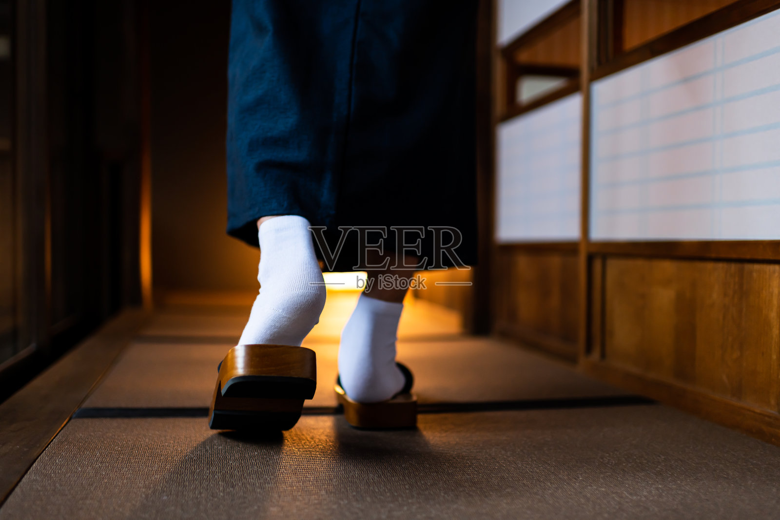 日本日式传统房子和男人在和服后的特写腿脚与tabi白色袜子和得到鞋走过shoji滑动纸门和榻榻米地板照片摄影图片