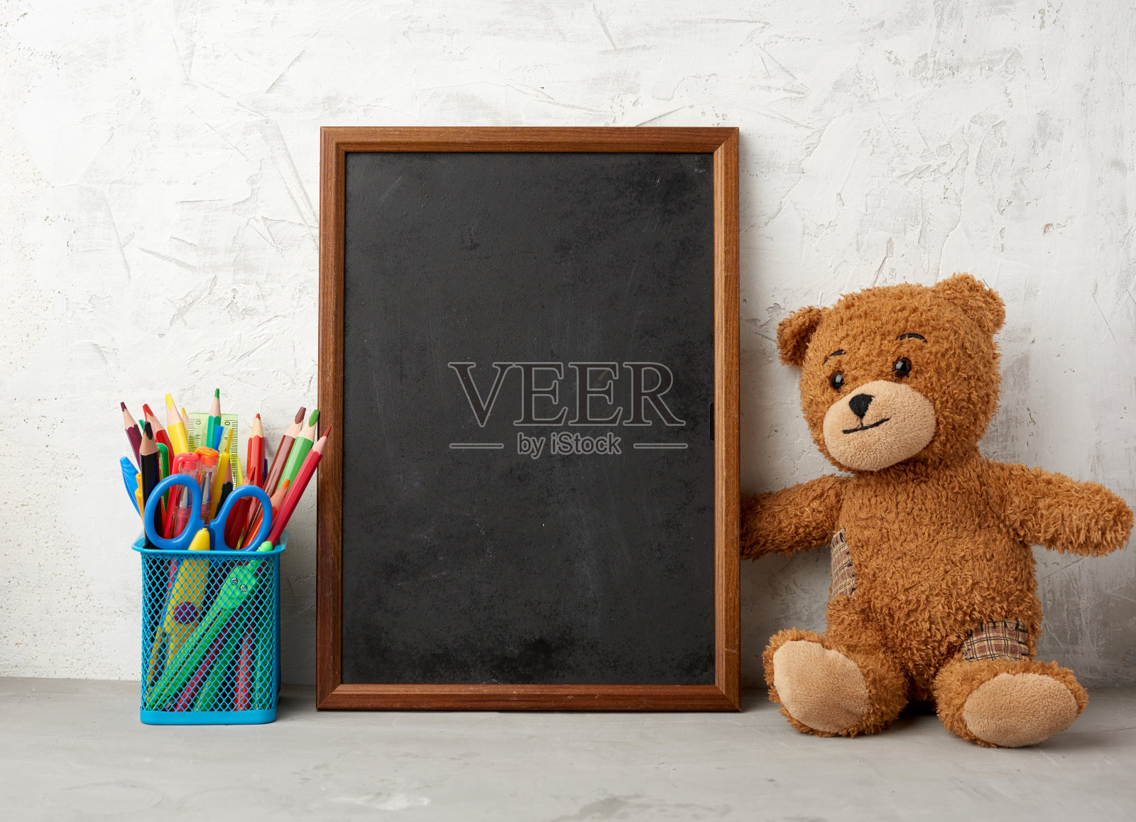 棕色的泰迪熊和空的木制矩形框架，写待办事项的黑板照片摄影图片