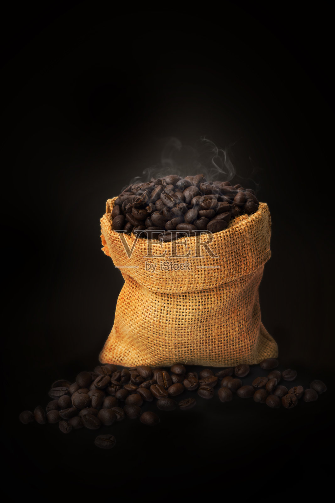 咖啡豆在袋子孤立的黑色背景和烟热烤咖啡豆照片摄影图片