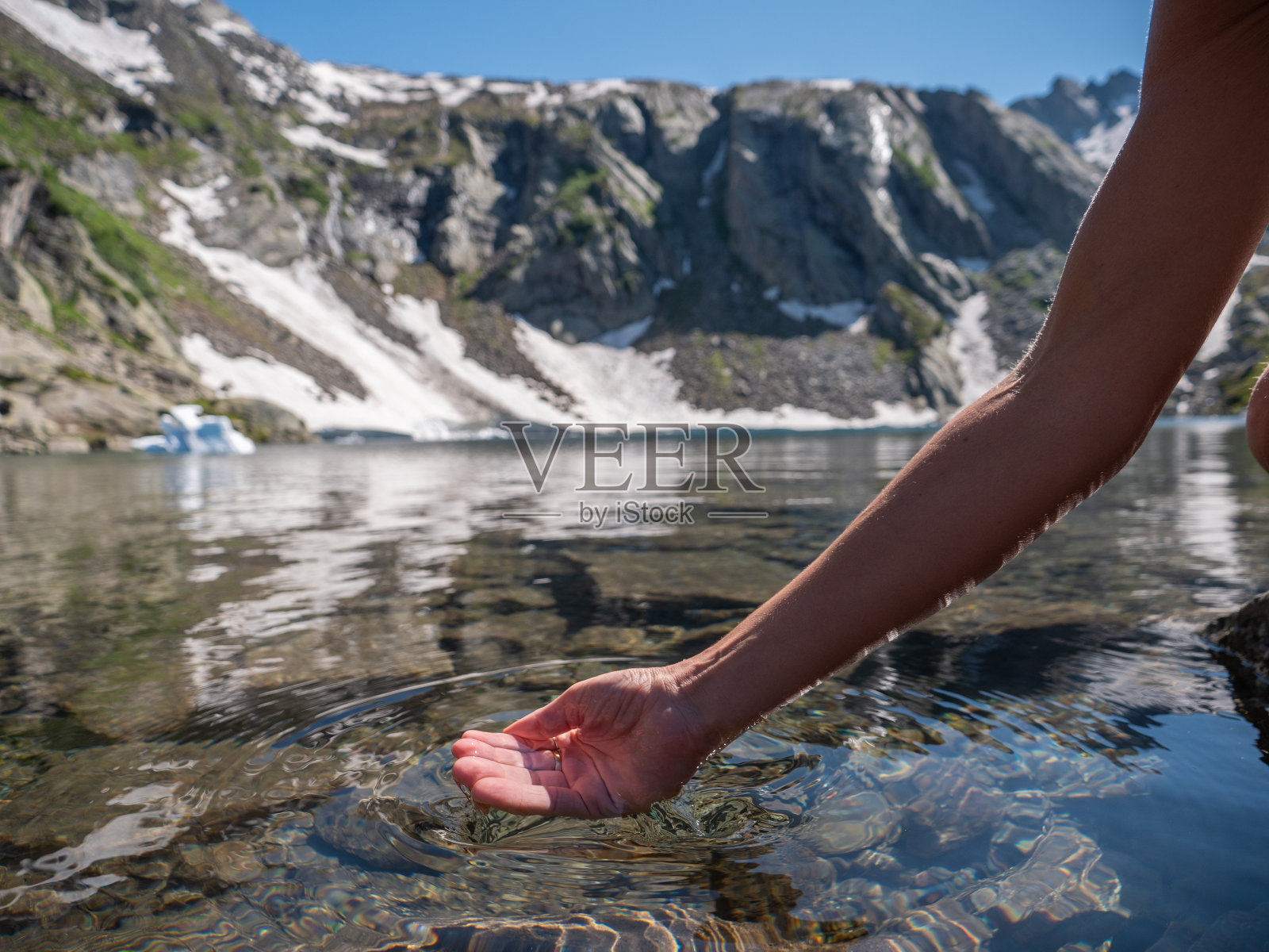 在瑞士，人们用手从山上的湖中舀取淡水照片摄影图片