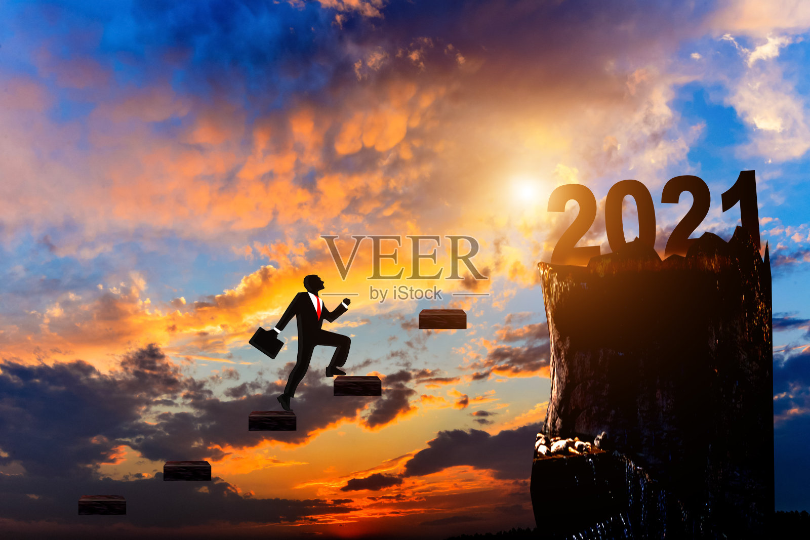 日出时分，一位商人踏上了2021年山顶的台阶。照片摄影图片