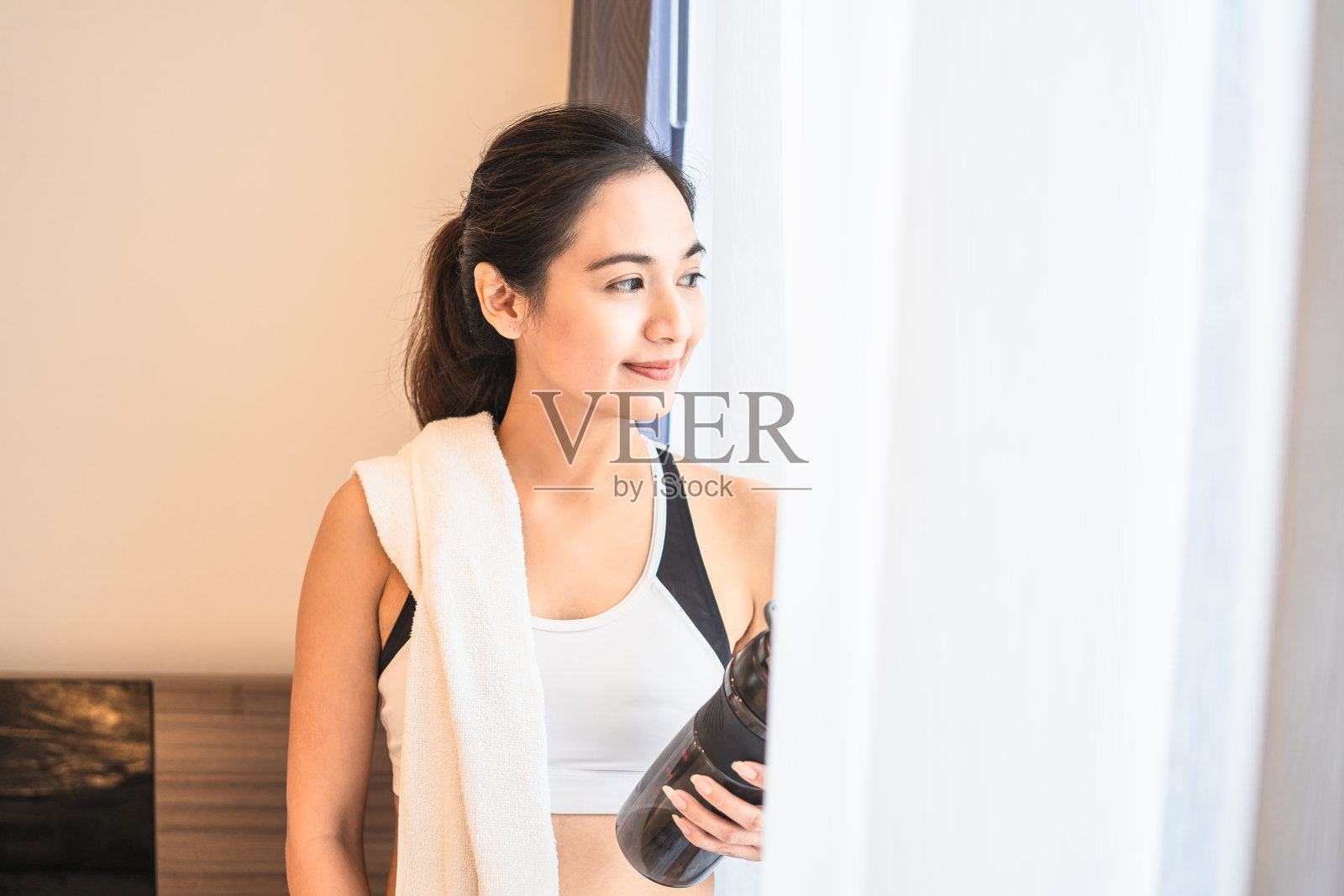 亚洲妇女微笑后，独自锻炼在家作为新的正常生活方式照片摄影图片