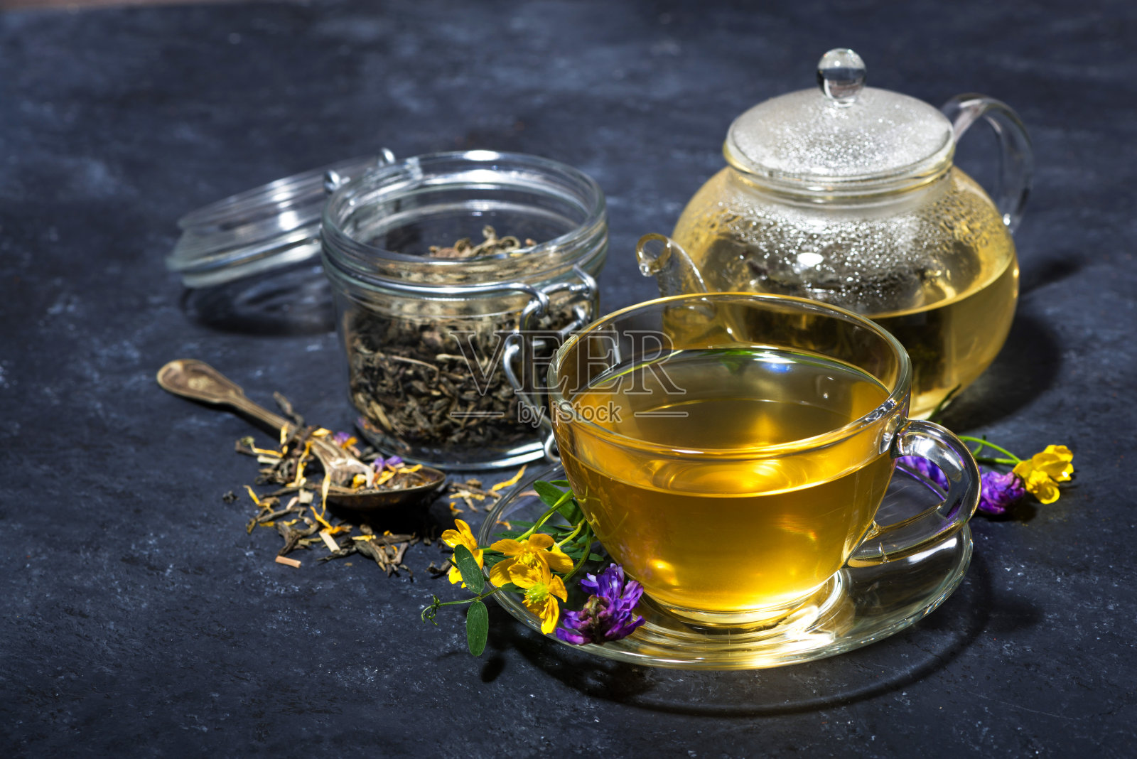一杯新鲜的茶与芳香的香草在一个黑暗的背景照片摄影图片