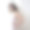 年轻迷人的画像与短头发在婚礼礼服。她站在白色的墙壁上，右边没有空间。快乐的新娘。素材图片