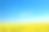 蓝蓝的天空映衬着黄色开花的油菜田素材图片