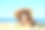 阳光明媚的日子里，一个可爱的小孩躺在沙滩上素材图片