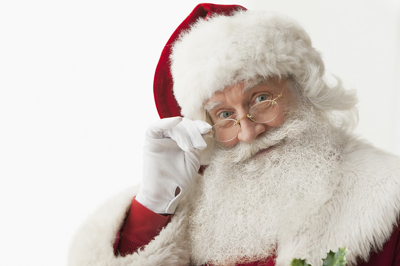 圣诞老人触摸眼镜的特写图片下载